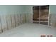 Room with exposed wall studs and damaged flooring at 2044 Montana Ne Ave, St Petersburg, FL 33703