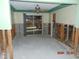 Room with exposed wall studs and damaged flooring at 2044 Montana Ne Ave, St Petersburg, FL 33703