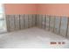 Room with exposed wall studs and damaged flooring at 2044 Montana Ne Ave, St Petersburg, FL 33703