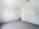 Bright bedroom features neutral carpeting, vaulted ceiling with fan, and a double-door closet at 8726 Latham Drive, Hudson, FL 34667