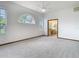 Spacious main bedroom with natural light and carpet flooring, adjacent bathroom is visible at 8726 Latham Drive, Hudson, FL 34667