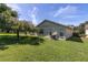 Spacious backyard with lush lawn and mature tree providing shade at 4750 Carrington Ct, New Port Richey, FL 34655