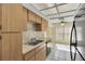 Kitchen with wood cabinets, stainless steel sink and appliances at 4750 Carrington Ct, New Port Richey, FL 34655