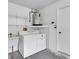 Garage with water heater, shelving, and laundry hookups at 4750 Carrington Ct, New Port Richey, FL 34655
