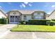 Charming house exterior with double doors and manicured lawn at 4750 Carrington Ct, New Port Richey, FL 34655