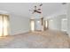 Spacious living room with wall-to-wall carpet and ceiling fan at 4750 Carrington Ct, New Port Richey, FL 34655