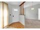 Entryway with hardwood floors, a half wall, and a chandelier at 4750 Carrington Ct, New Port Richey, FL 34655