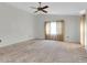 Spacious living room with wall-to-wall carpet and ceiling fan at 4750 Carrington Ct, New Port Richey, FL 34655