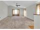 Bright living room featuring a ceiling fan and ample space at 4750 Carrington Ct, New Port Richey, FL 34655