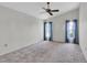 Large bedroom with ceiling fan and neutral colored walls at 4750 Carrington Ct, New Port Richey, FL 34655