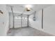 Garage with concrete floor, shelving, and laundry hookups at 4750 Carrington Ct, New Port Richey, FL 34655
