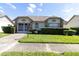 Charming house exterior with double doors and manicured lawn at 4750 Carrington Ct, New Port Richey, FL 34655