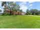 Single-story home with tile roof, lush landscaping, and spacious lawn at 2044 Montana Ne Ave, St Petersburg, FL 33703