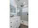 Modern bathroom with gray tile, frameless shower, and white vanity at 3448 Triggerfish Dr, Hernando Beach, FL 34607