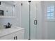 Clean bathroom with white vanity, frameless shower, and marble countertop at 3448 Triggerfish Dr, Hernando Beach, FL 34607