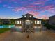 Two story waterfront home with attached two car garage at dusk at 3448 Triggerfish Dr, Hernando Beach, FL 34607