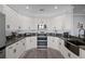 Modern kitchen with dark countertops and white cabinets at 3448 Triggerfish Dr, Hernando Beach, FL 34607