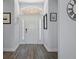 Bright entryway with wood-look flooring and an arched window at 3448 Triggerfish Dr, Hernando Beach, FL 34607