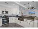 Modern kitchen with white cabinets, farmhouse sink, and dark countertops at 3448 Triggerfish Dr, Hernando Beach, FL 34607