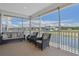 Relaxing screened porch overlooking the water with wicker furniture at 3448 Triggerfish Dr, Hernando Beach, FL 34607
