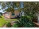 Partial view of the home's exterior and backyard landscaping at 1183 Mystic Ct, Spring Hill, FL 34609