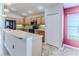 Bright kitchen with wood cabinets, black appliances, and a large countertop at 1183 Mystic Ct, Spring Hill, FL 34609