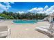 Community pool with lounge chairs and plenty of space for relaxation at 1183 Mystic Ct, Spring Hill, FL 34609