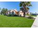 Single-story house with a palm tree and well-maintained lawn at 1183 Mystic Ct, Spring Hill, FL 34609