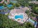 Aerial view of community pool, tennis courts, and clubhouse at 1183 Mystic Ct, Spring Hill, FL 34609