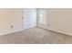Bright bedroom with neutral walls and carpet, featuring a double door closet and window at 1183 Mystic Ct, Spring Hill, FL 34609