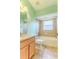 Light green bathroom with single vanity and tub shower combo at 1183 Mystic Ct, Spring Hill, FL 34609