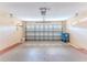 Clean garage with open overhead door, storage, and painted floor at 1183 Mystic Ct, Spring Hill, FL 34609