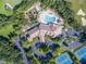 Aerial view of community clubhouse, pool, and tennis courts at 1183 Mystic Ct, Spring Hill, FL 34609
