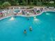 Aerial view of community pool with residents enjoying a summer evening at 1183 Mystic Ct, Spring Hill, FL 34609