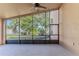 Relaxing screened porch overlooking the backyard with ceiling fan at 1183 Mystic Ct, Spring Hill, FL 34609