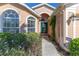 Welcoming front entry with a teal door and lush landscaping at 1183 Mystic Ct, Spring Hill, FL 34609