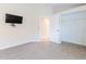 Bedroom with wall-mounted TV and walk-in closet at 1183 Mystic Ct, Spring Hill, FL 34609