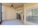 Bright screened porch with ceiling fan and sliding glass door at 1183 Mystic Ct, Spring Hill, FL 34609
