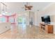 Spacious living room with tile floors and access to a covered patio at 1183 Mystic Ct, Spring Hill, FL 34609
