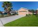 House exterior with driveway and palm tree at 1183 Mystic Ct, Spring Hill, FL 34609