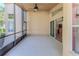 Spacious screened porch with ceiling fan and access to the backyard at 1183 Mystic Ct, Spring Hill, FL 34609