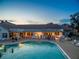 Evening view of resort-style pool with clubhouse in background at 1183 Mystic Ct, Spring Hill, FL 34609