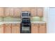 Kitchen features black appliances and light wood cabinets at 1183 Mystic Ct, Spring Hill, FL 34609