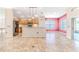 Kitchen with light wood cabinets, black appliances, and breakfast bar at 1183 Mystic Ct, Spring Hill, FL 34609