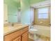 Light green bathroom with single vanity and tub shower combo at 1183 Mystic Ct, Spring Hill, FL 34609