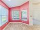 Charming breakfast nook with pink walls, tile flooring, and window seats at 1183 Mystic Ct, Spring Hill, FL 34609