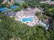 Aerial view of community pool, tennis courts, and clubhouse at 1183 Mystic Ct, Spring Hill, FL 34609