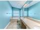 Bathroom with double sinks, garden tub, and light blue walls at 1183 Mystic Ct, Spring Hill, FL 34609