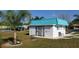 Community building with a teal roof and white walls at 4201 Avanti Cir, New Port Richey, FL 34655