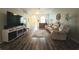 Living room with hardwood floors, sectional sofa, and large TV at 4201 Avanti Cir, New Port Richey, FL 34655